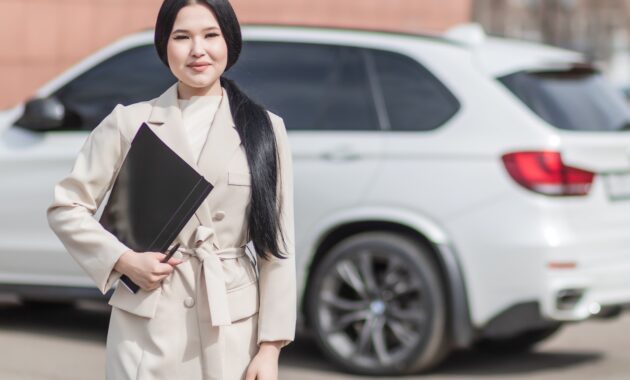 Woman in Beige Corporate Clothes Holding Black Folder